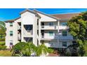 Condo exterior featuring balconies and manicured landscaping at 8755 Olde Hickory Ave # 7302, Sarasota, FL 34238