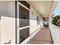 Exterior condo hallway with a screen door and view at 8755 Olde Hickory Ave # 7302, Sarasota, FL 34238