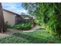 Screened patio with brick pavers and lush foliage at 1155 Hampton Rd, Sarasota, FL 34236