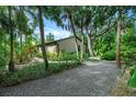 Landscaped backyard with gravel pathway and tropical plants at 1155 Hampton Rd, Sarasota, FL 34236