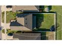 Aerial view of a fenced backyard with green grass, along with view of the home and neighborhood at 14318 Fissore Blvd, Wimauma, FL 33598