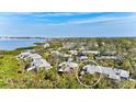 Serene aerial view shows home amid verdant landscaping, close to waterfront and the city at 1447 Landings Cir # 68, Sarasota, FL 34231