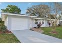 Well-kept single-story home with a spacious driveway and a welcoming entrance at 2079 Pellam Blvd, Port Charlotte, FL 33948