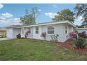 Inviting single Gathering home featuring a well-maintained lawn and lush landscaping at 2079 Pellam Blvd, Port Charlotte, FL 33948