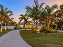 Stunning waterfront home nestled amongst lush tropical landscaping at 221 Lychee Rd, Nokomis, FL 34275