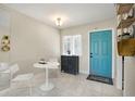 Bright entryway featuring tile floors, a decorative cabinet and blue front door at 2211 Sunset Dr # E3, Bradenton, FL 34207