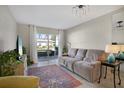 Living room with a large window, neutral colored sofa and area rug at 2211 Sunset Dr # E3, Bradenton, FL 34207