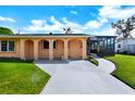 Orange house with arched entryway and driveway at 2822 Maple Ave, Sarasota, FL 34234