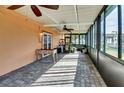 Spacious screened porch with tile flooring and ceiling fans at 2822 Maple Ave, Sarasota, FL 34234