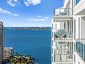 Condo balcony with seating offers stunning waterfront views perfect for relaxing and entertaining at 301 Quay Commons # 1809, Sarasota, FL 34236