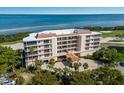 Aerial view of a luxurious condo building near the water at 3070 Grand Bay Blvd # 625, Longboat Key, FL 34228