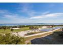 Stunning view of a golf course with water features and palm trees at 3070 Grand Bay Blvd # 625, Longboat Key, FL 34228