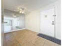 Bright living room with tile flooring, mirror wall and fan, offering ample natural light at 3273 Beneva Rd # 101, Sarasota, FL 34232