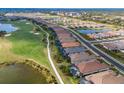 High angle view of homes arranged in a row along a golf course and lakes at 3860 Santa Caterina Blvd, Bradenton, FL 34211