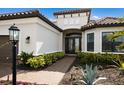 Elegant front entrance with double doors, beautiful landscaping, and brick walkway at 3860 Santa Caterina Blvd, Bradenton, FL 34211