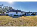 Side view of a single-story home with a well-maintained lawn at 3990 Overlook Bnd # 19, Sarasota, FL 34232