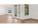 Bright foyer with double glass front doors, luxury vinyl floors, and neutral decor at 4244 Reflections Pkwy, Sarasota, FL 34233