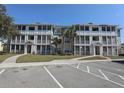 Exterior view of condominiums with screened-in porches and well-maintained landscaping at 4802 51St W St # 613, Bradenton, FL 34210