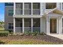 Close-up of a condo entrance featuring a screened-in porch and well-kept garden at 4802 51St W St # 613, Bradenton, FL 34210