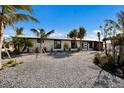 Beautifully landscaped home with mature palms and a circular drive at 505 65Th St, Holmes Beach, FL 34217