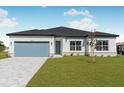 Single-story home with light-colored exterior, gray pavers, and a landscaped lawn at 514 Santiguay St, Punta Gorda, FL 33983