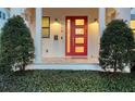 Inviting front entryway highlighting the bright red door, sconces, and decorative shrubbery at 515 S Osprey Ave, Sarasota, FL 34236