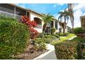 Close up exterior of the condo complex showing off the beautiful landscaping at 5251 Mahogany Run Ave # 526, Sarasota, FL 34241