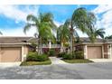 Attached garage condo complex featuring a beautiful landscaped walkway at 5251 Mahogany Run Ave # 526, Sarasota, FL 34241