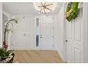 Bright and airy entryway with light hardwood floors at 5300 Manorwood Dr, Sarasota, FL 34235