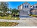 Charming two-story townhome featuring a well-manicured lawn, neutral paint, and attached two-car garage at 5580 Pleasantview Ct, Lakewood Ranch, FL 34211