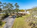 Home exterior featuring a spacious front yard and beautiful mature trees at 5630 Saint Louis Ave, Sarasota, FL 34233