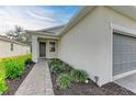 Front entrance of a new home with walkway and landscaping at 5866 Bungalow Grove Ct, Palmetto, FL 34221