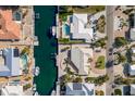 Birds-eye view of canal-front homes, pools, and neighborhood streets at 627 Dundee Ln, Holmes Beach, FL 34217