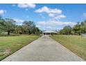 Spacious lot with a long concrete driveway leading to a home with a three-car garage at 6521 121 St E Ave, Parrish, FL 34219