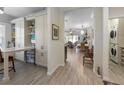 Bright hallway featuring built-in shelving, a drop-down table, wood floors, and a utility room with washer and dryer at 6912 Playa Bella Dr, Bradenton, FL 34209