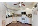 Well-equipped kitchen with white cabinetry and tile backsplash at 803 Montrose Dr # 201, Venice, FL 34293