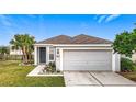 House exterior featuring a two-car garage and well-manicured lawn at 9918 50Th Street E Cir, Parrish, FL 34219