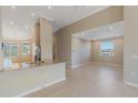 Bright living room/kitchen combo featuring granite countertops, stainless steel appliances, and tile flooring at 12410 Osorio Ct # 201, Sarasota, FL 34238