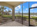 Screened in lanai with brick pavers offering serene lake views and lush landscaping at 16904 Vardon Ter # 102, Bradenton, FL 34211