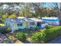 Single story house with green exterior, tree-lined street at 2040 Palm Ter, Sarasota, FL 34231