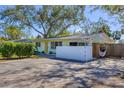 Light green house with yellow door and white wall, hammock visible at 2040 Palm Ter, Sarasota, FL 34231