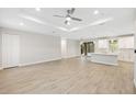 Bright, open living area featuring wood-look tile, recessed lighting, and seamless transition to the outdoors at 336 Milford St, Port Charlotte, FL 33953