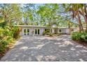 Well-maintained home featuring a circular driveway and a meticulously landscaped front yard at 3705 Tangier Ter, Sarasota, FL 34239