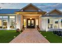 Elegant front entrance featuring double doors, brick walkway, and manicured landscaping at 3759 Beneva Oaks Blvd, Sarasota, FL 34238