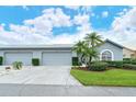 Gray house with attached garage and landscaping at 4147 Marseilles Ave # 3068, Sarasota, FL 34233