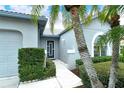 Front entry with gray walls, landscaping and walkway at 4147 Marseilles Ave # 3068, Sarasota, FL 34233