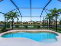 Beautiful swimming pool with screened enclosure and view of the backyard and lake at 4617 Garden Arbor Way, Bradenton, FL 34203