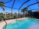 Inviting pool within a screened enclosure, offering a relaxing retreat with views of the lake and surrounding homes at 4617 Garden Arbor Way, Bradenton, FL 34203