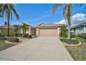 Charming single-story home featuring a two-car garage and lush, landscaped front yard at 4969 Creekside Trl, Sarasota, FL 34243