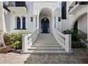 Stunning front entrance with custom railings, an arched entry, and beautiful pavers at 500 Harbor Point Rd, Longboat Key, FL 34228